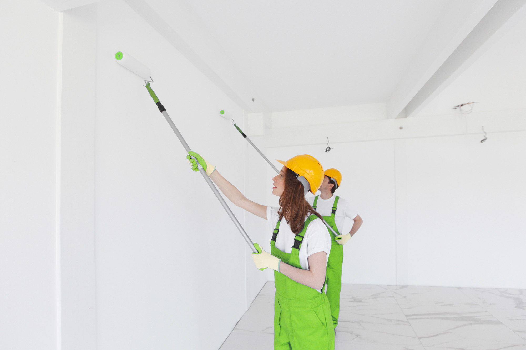 Maintenance other. Painting the Roof of the House with a Paint Roller.